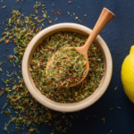 Bowl containing lemon slices and a mix of herbs.